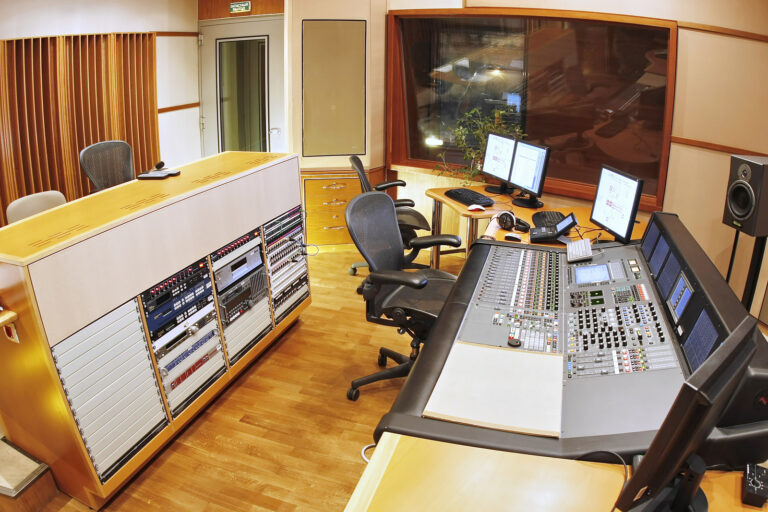 A shot of a professional recording studio, complete with technical equipment.